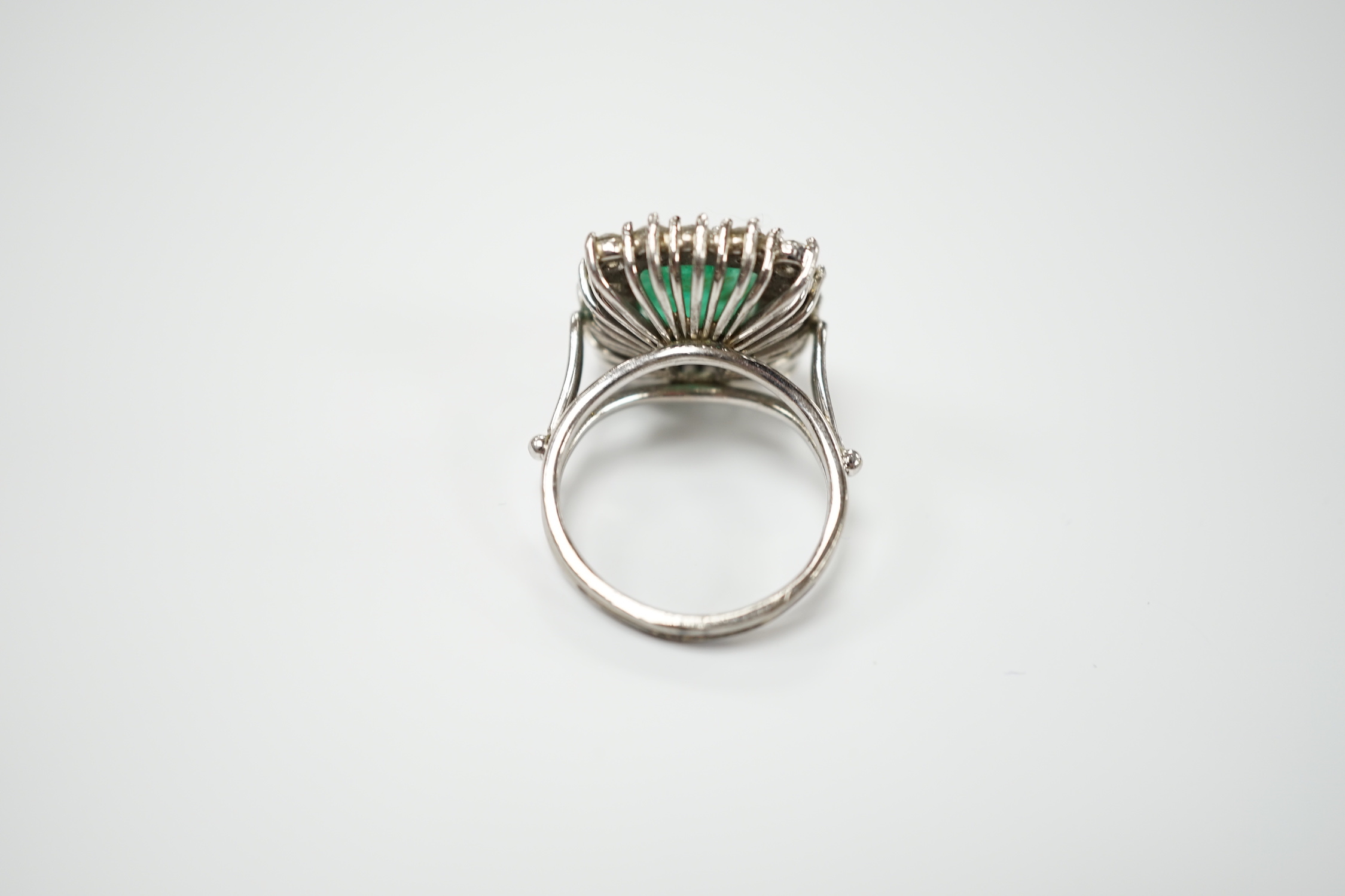 A white metal, emerald and diamond set square cluster ring, size I, gross weight 6.3 grams.